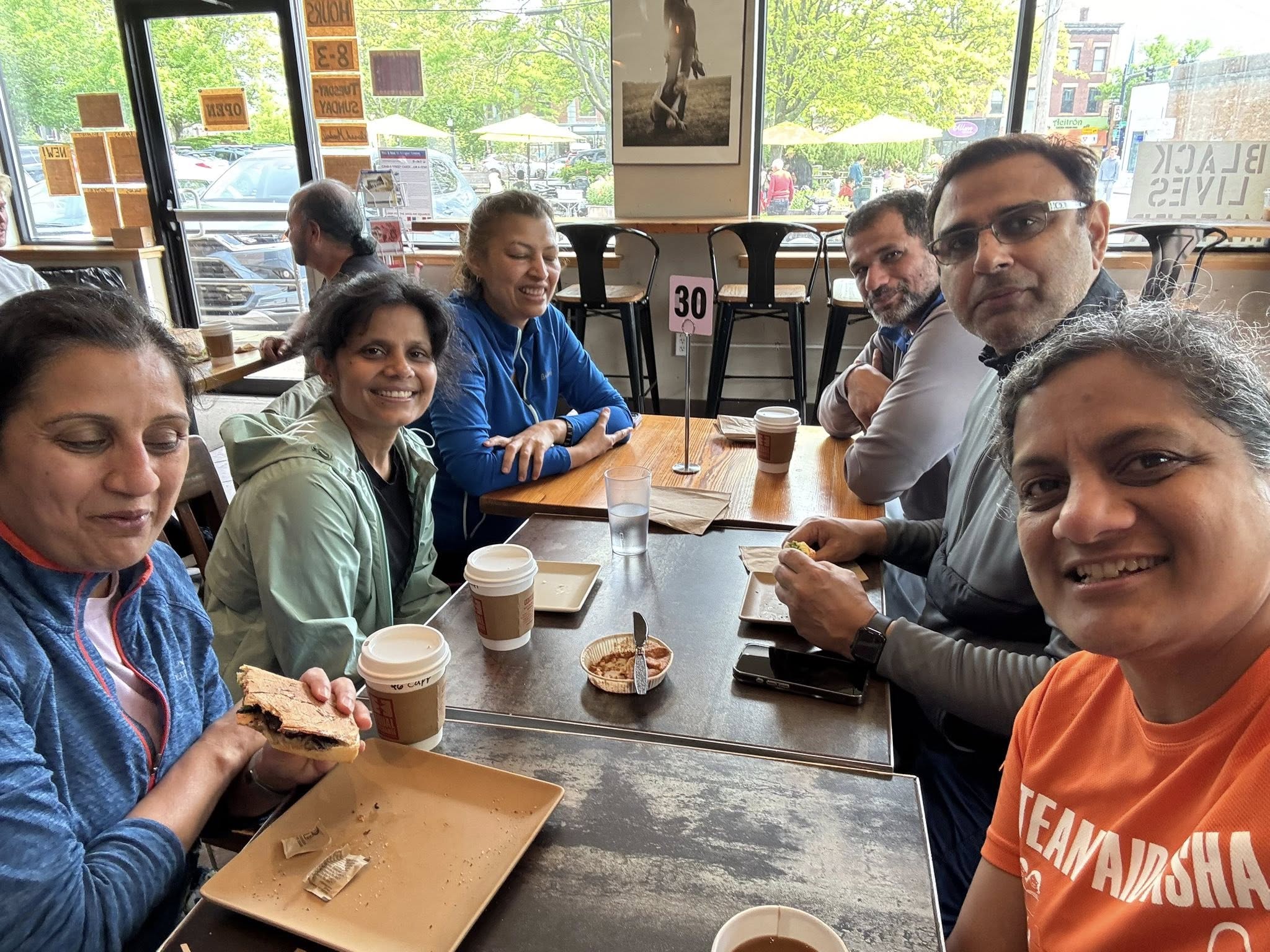 Team posing in a tree by the river