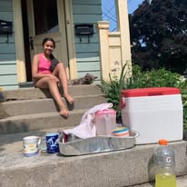 Group running along river path with cherry blossoms